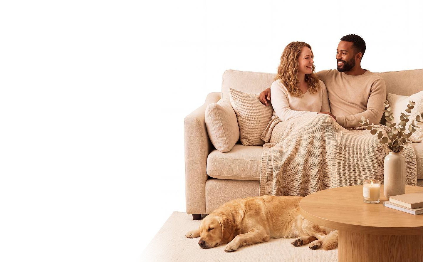 Couple relaxing on a sofa at home with their dog